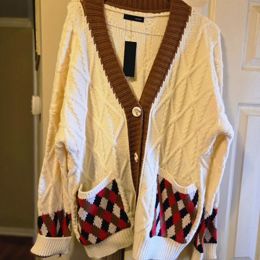 On Blue L off white cardigan with brown, red, & black accents on front pockets